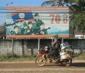 Motorcyclist past communist sign