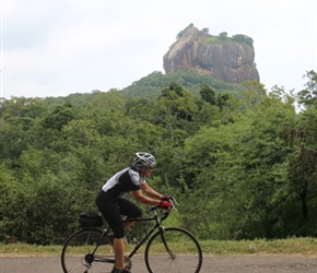 Dianne Young cycles past Sigiriya Rock Fortress