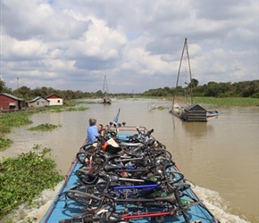 Bikes and Valerie on Tonle Sap River