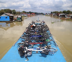 Bikes and village on Tonle Sap River