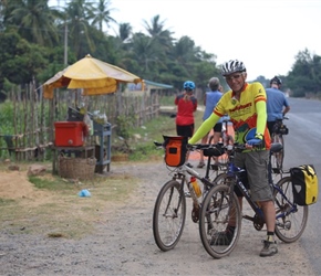 Jack holds bike on Road to Sihanoukville, Cambodia