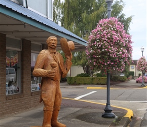 Created with a chainsaw, this man waving us goodbye with his hat adorned the pavement in Reedsport