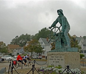 John and Janet approach the fisherman by wheel statue in Gloucester. Gloucester Fisherman's Memorial (also known as: "Man at the Wheel" statue or "Fishermen's Memorial Cenotaph") is a historic memorial cenotaph sculpture on South Stacy Boulevard, nea
