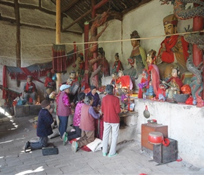 Ladies worshipping at the roadside temple