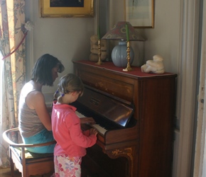 Jo and Kate test out the piano at the chateau