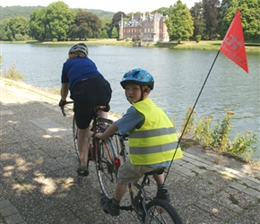Penny and Oliver cycle pas John Chateau on the River Meuse