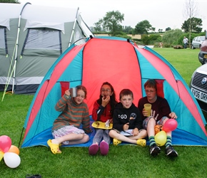 Louise, Lucy, Finlay and James enjoy the BBQ in the play tent