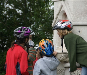Lucy, Louise and Catherine gather around the Chillingham Memorial