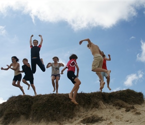 Anna, Robert, Katie, Caitlin, Ewan, Gordon and Chloe leaping the dunes