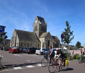 Sainte Mere Eglise. Paratroopers rained down on this Norman village as D-Day operations began in June 1944 to liberate Europe from German occupation. Famously, American soldier John Steele was left dangling a time from the medieval church