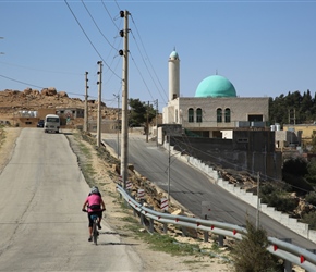 Mel heads past a mosque
