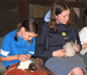 Flora and Sarah check out the rats and rabbits