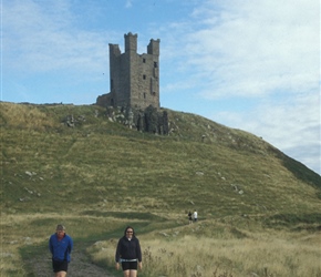John and Janice walk back from Dunstanburgh Castle
