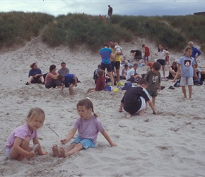 Louise and Ariane playing in the sand at Bamburgh Beach