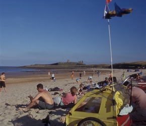 Trailer et al on the beach with Dunstanburgh Castle in the background