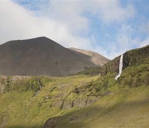 Bjarnarfoss is an 80 metre waterfall, behind the small farming hamlet of Buðir, opposite the Mælifell Volcano.