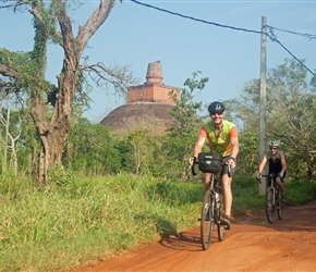 Robin cycles through Anuradhapura with Jethawanaramaya in the background