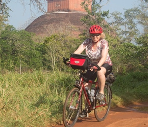 Linda cycles through Anuradhapura with Jethawanaramaya in the background
