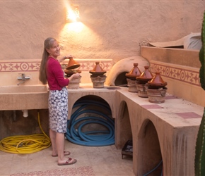 Sarah checks out the tagines for dinner. Cooked in the corner at the Riad, they were heated vis charcoal, a srt of Moroccan slow cooker