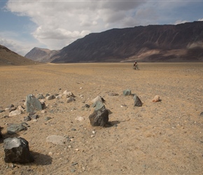 Along a long flat valley, old grave sites littered the floor