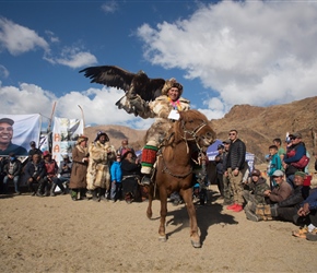 The winner of the 'mounted' eagle hunter leaves the prize giving area
