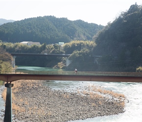 Sue crosses a cyclists bridge across the River Naka