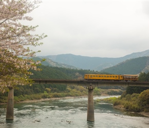 The Shiman Torocco Trolley tourist train crosses the Shimanto River