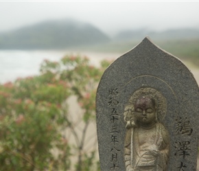 A small buddha statue overlooks Ohki Beach