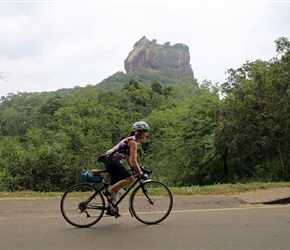 Christine Ratcliffe cycles past Sigiriya Rock Fortress